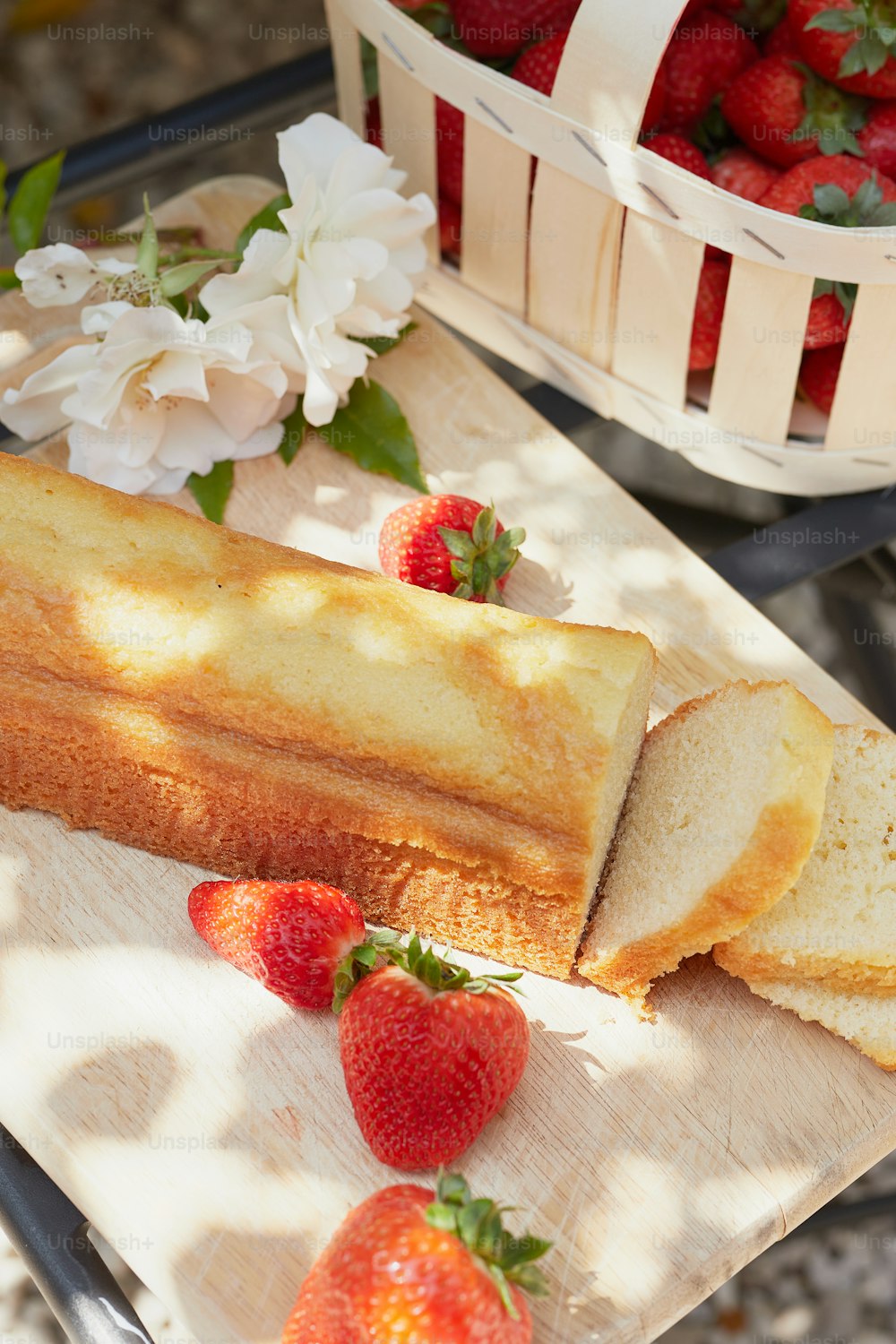 a loaf of bread and some strawberries on a table