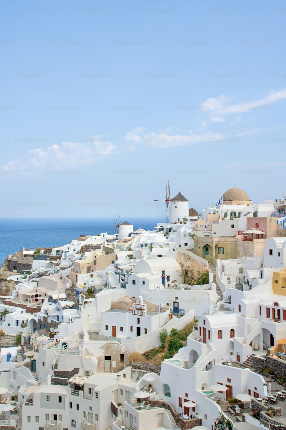 a view of a town with a windmill in the background