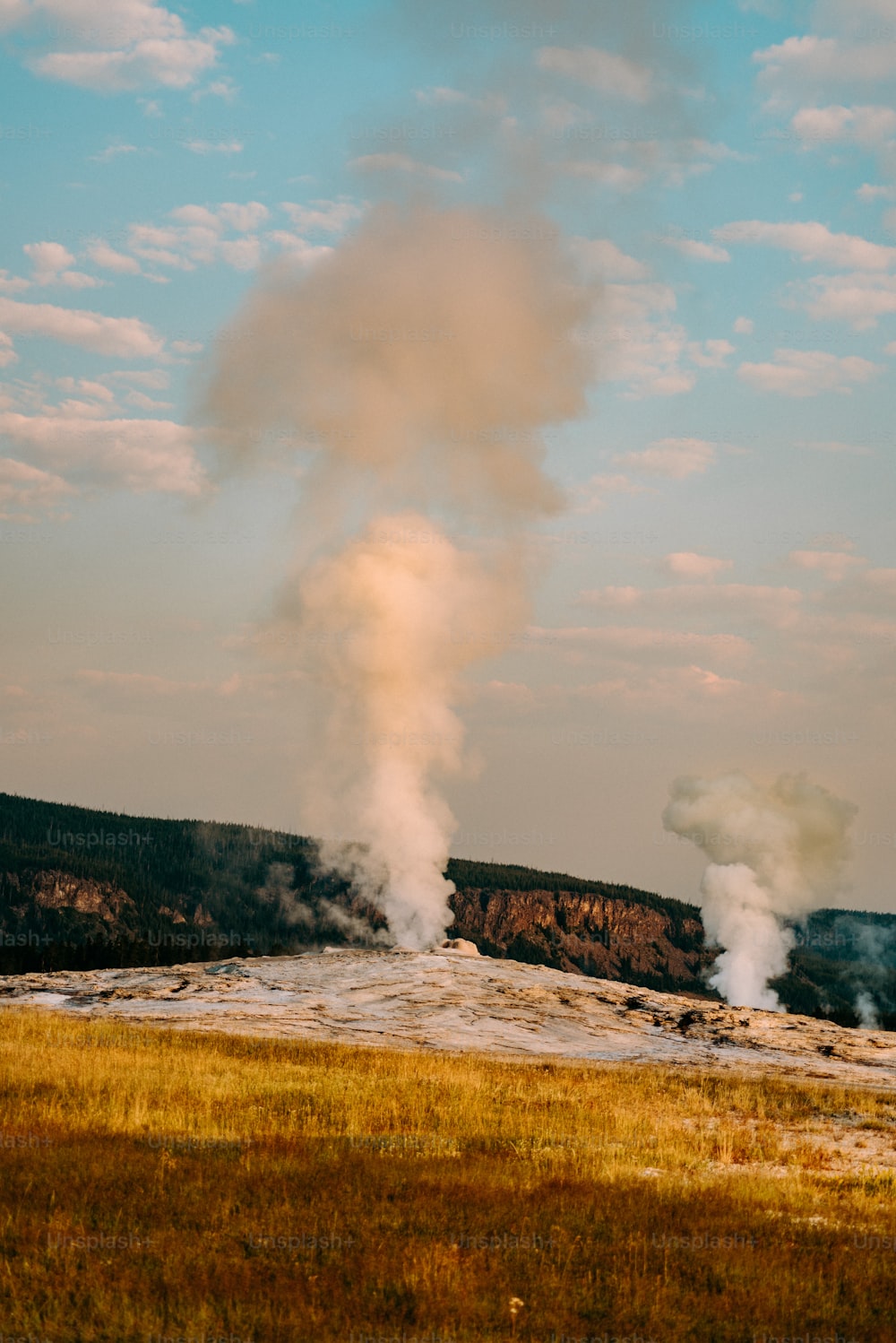 a large plume of steam rises into the sky