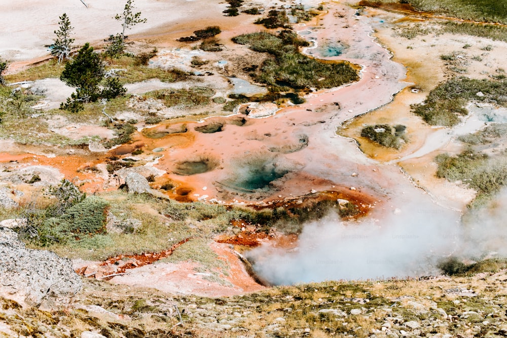 an aerial view of a hot spring in the mountains