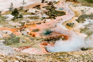 an aerial view of a hot spring in the mountains