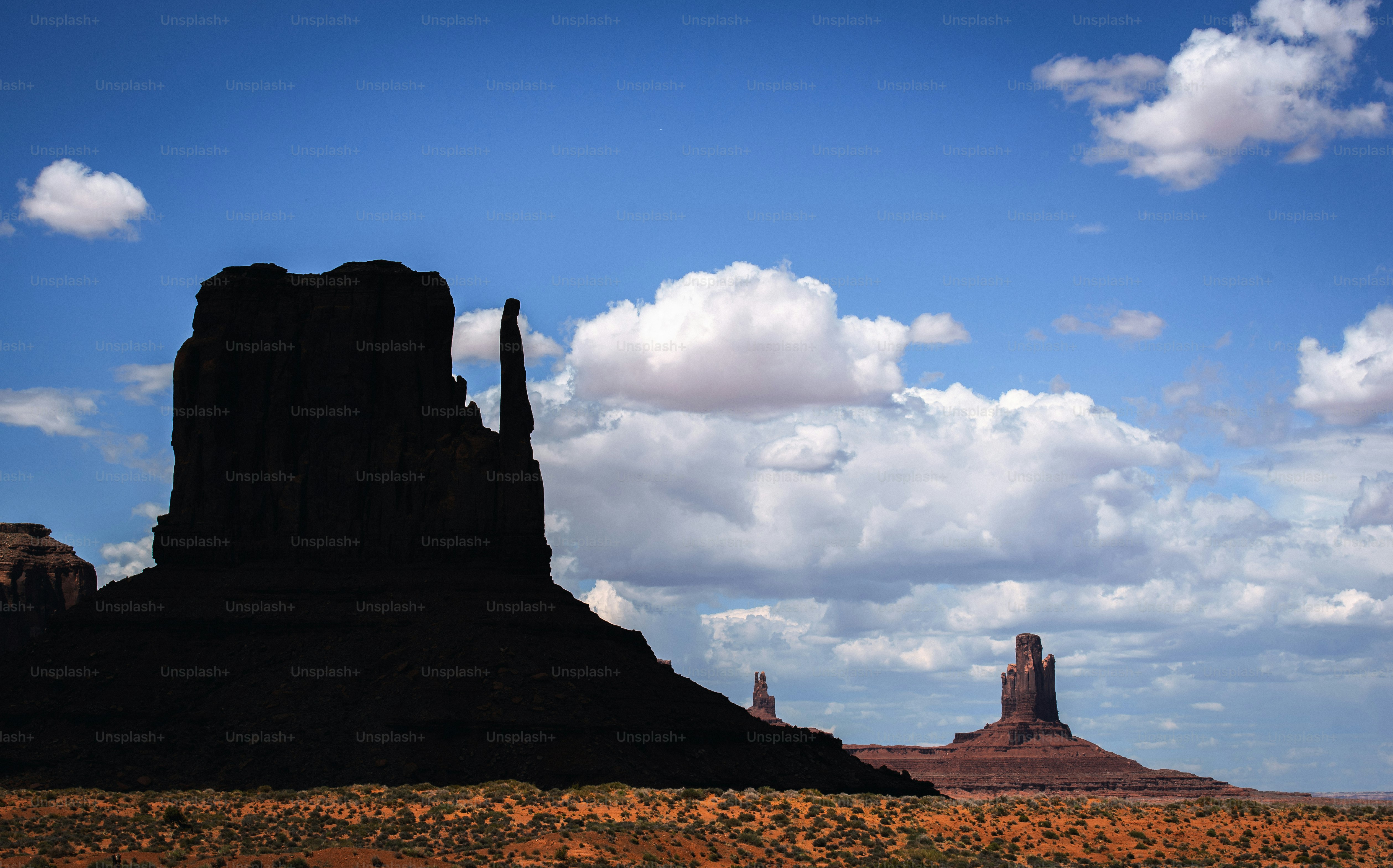 a large rock formation in the middle of a desert
