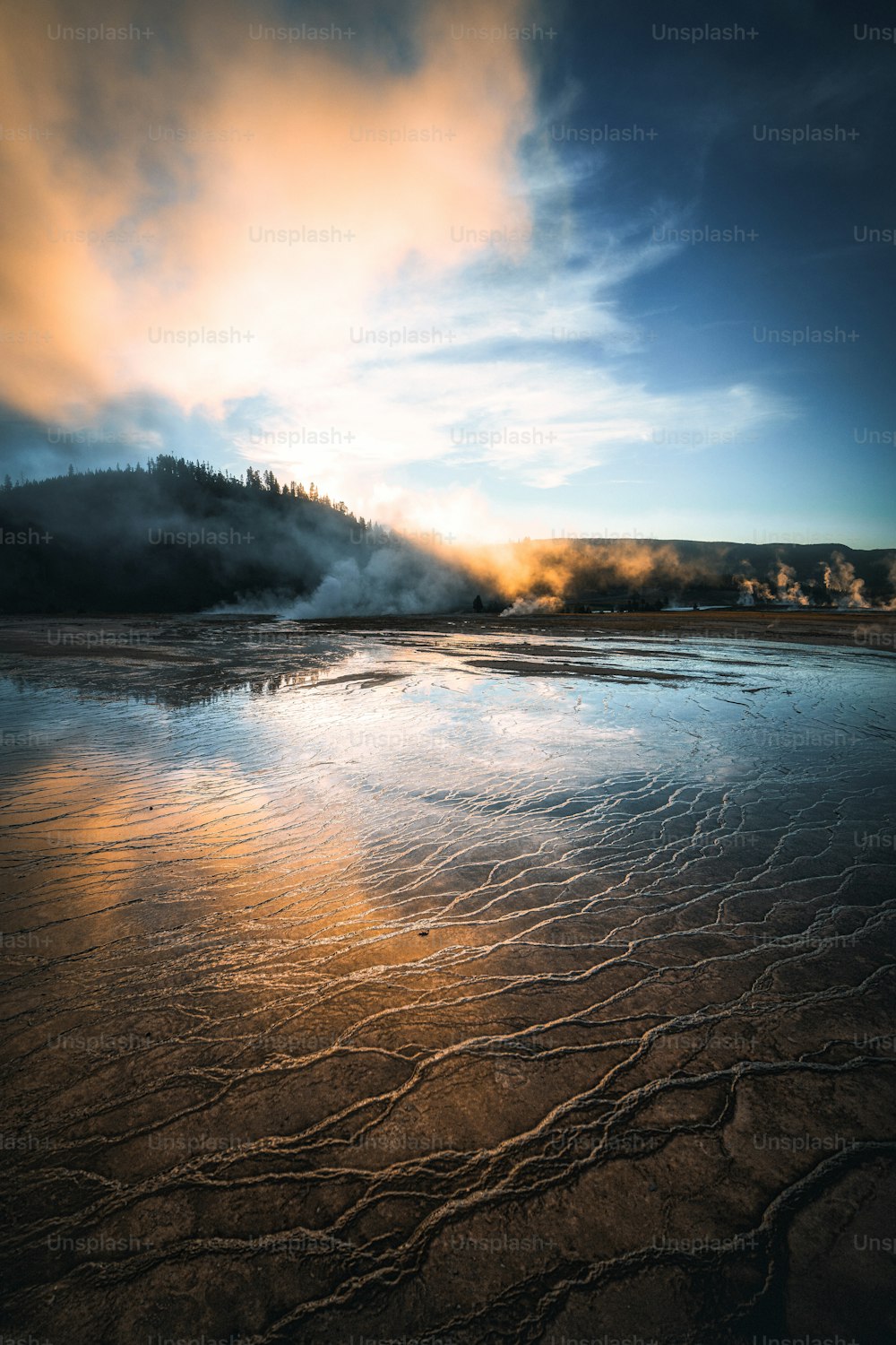 a large body of water with steam coming out of it