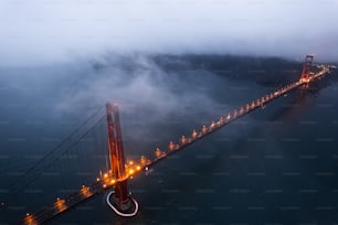 the golden gate bridge is lit up at night