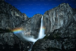 a waterfall with a rainbow in the middle of it