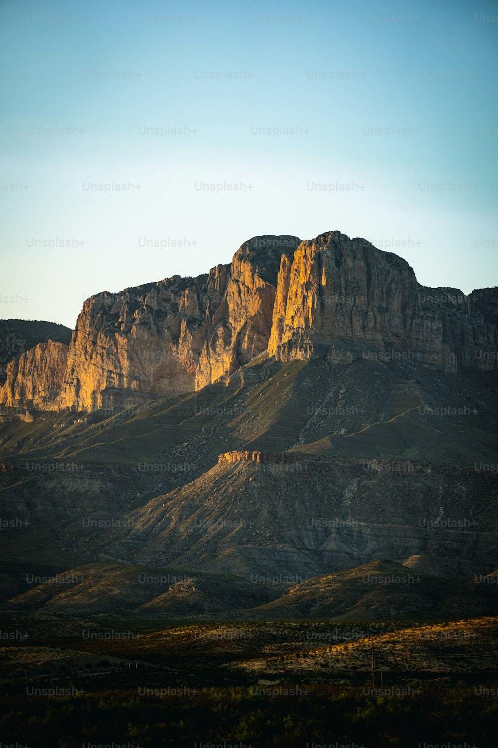 a large mountain with a very tall mountain in the background