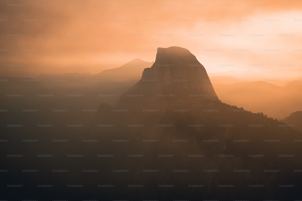 a large mountain with a very tall mountain in the background