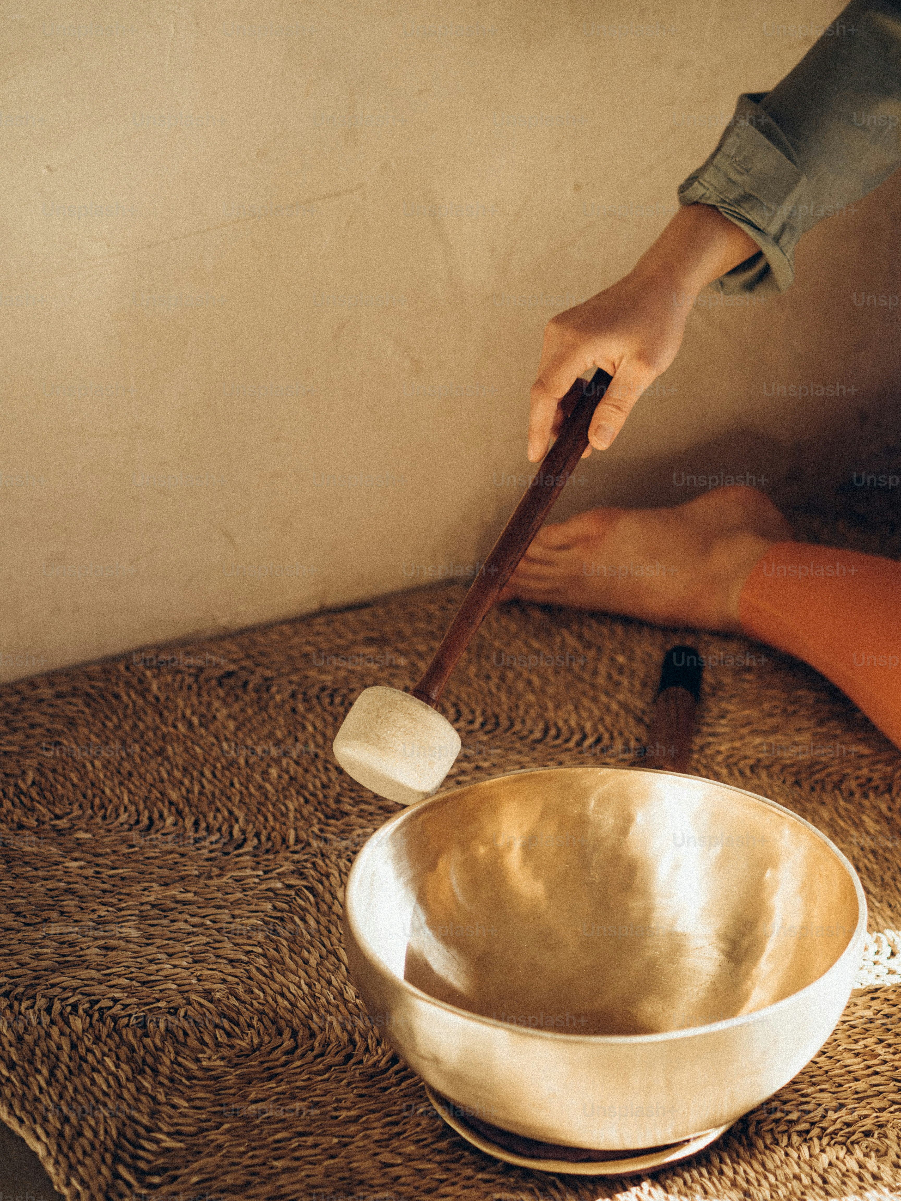 a person using a wooden spoon to stir food in a bowl
