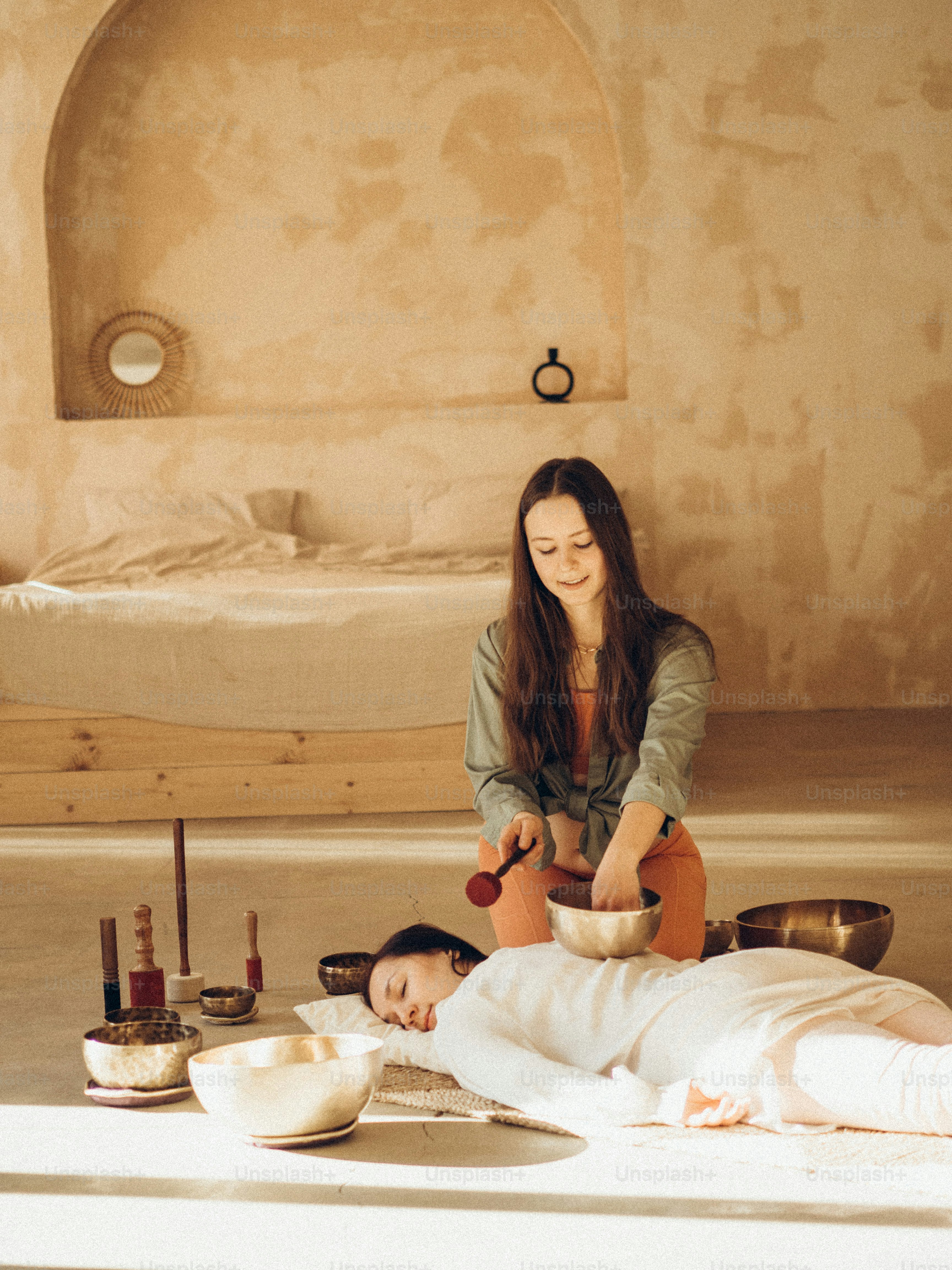 a woman sitting on the floor with a bowl of food