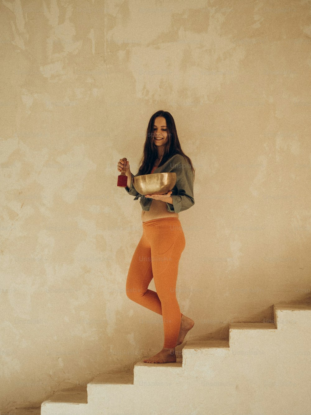 a woman is standing on a set of stairs
