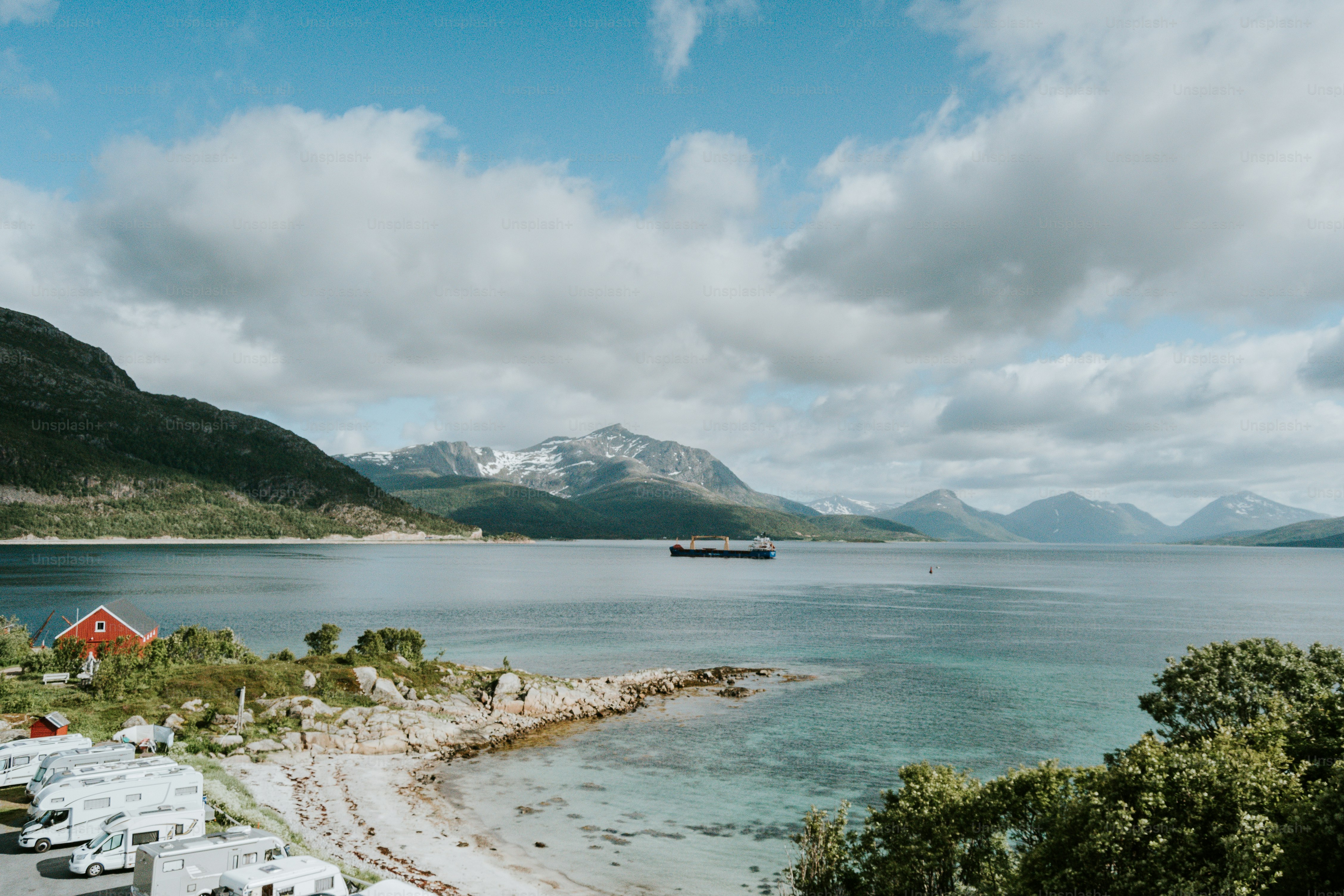 a body of water surrounded by mountains and trees
