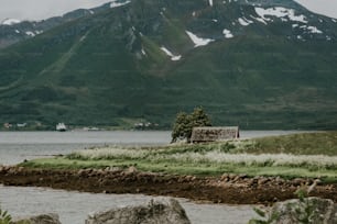a small hut sitting on a small island in the middle of a lake