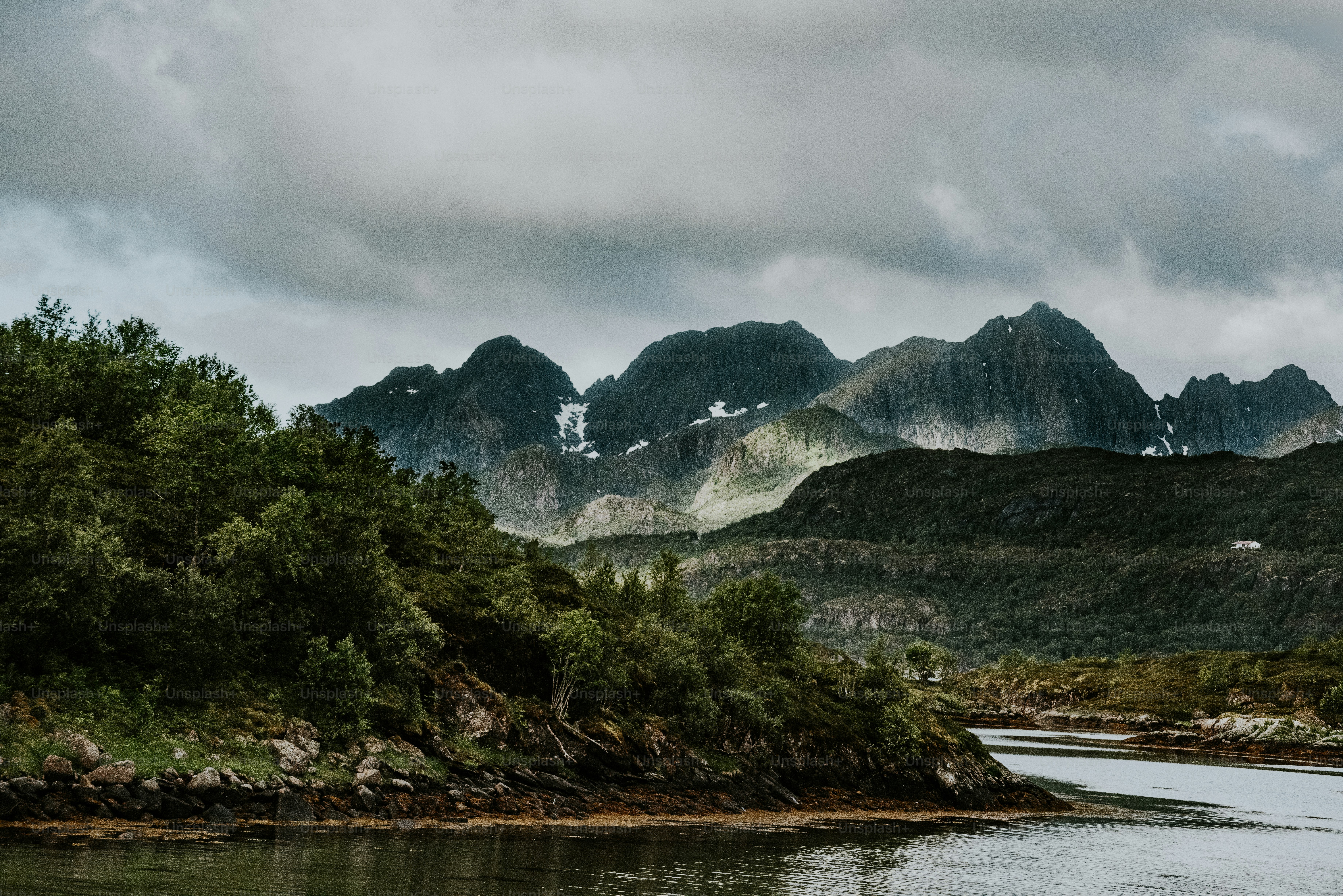 a body of water with mountains in the background