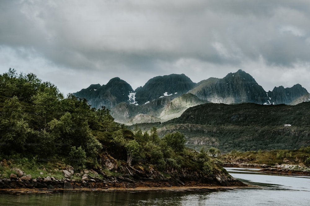 a body of water with mountains in the background