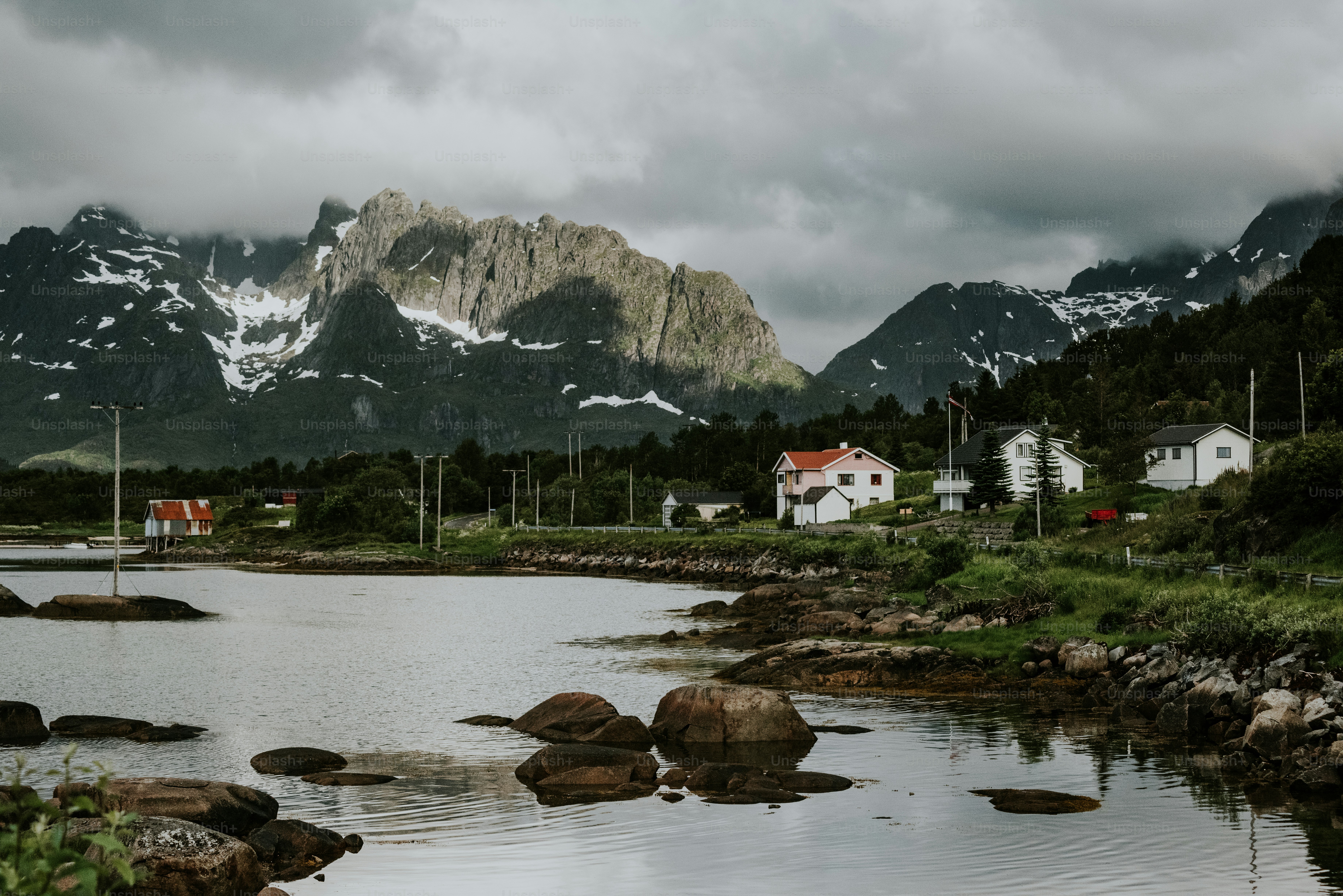 a lake surrounded by mountains and houses