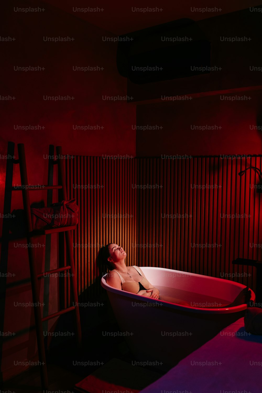 a woman in a bathtub in a dimly lit room