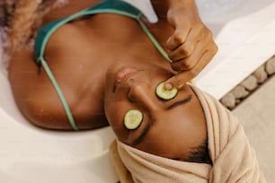 a woman with cucumber slices on her face