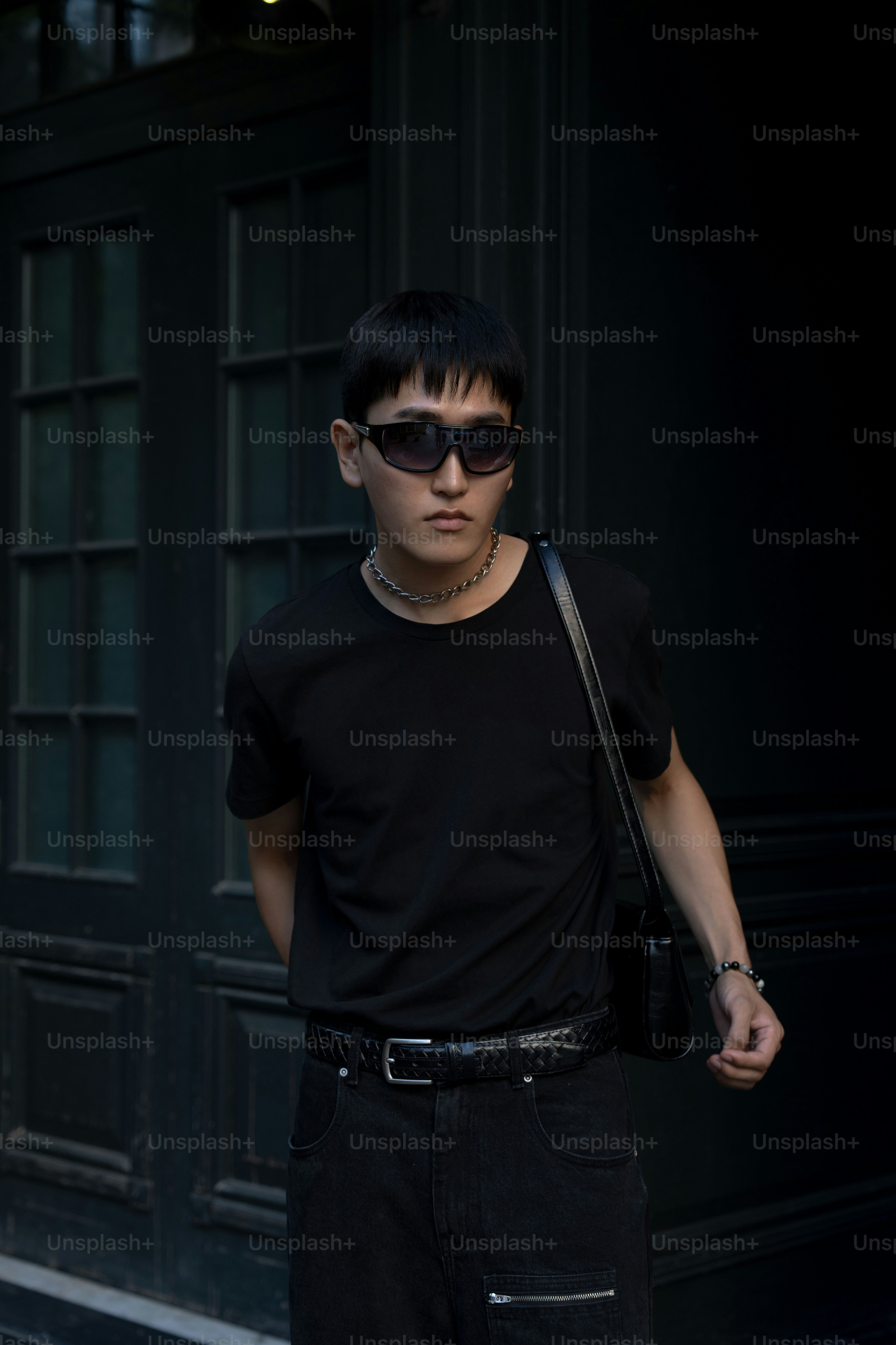 a young man wearing sunglasses and a black shirt