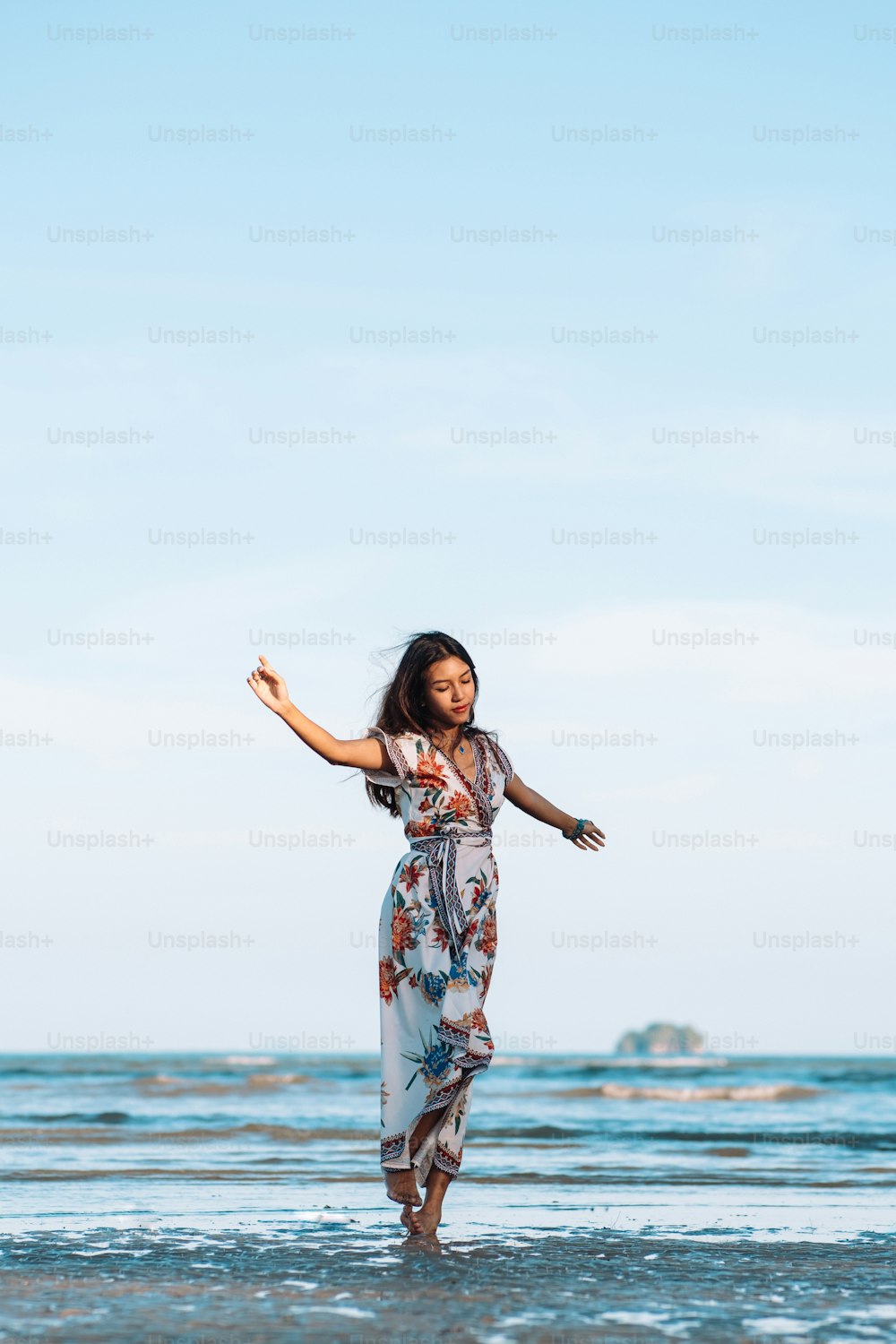 a woman standing in the water on a beach