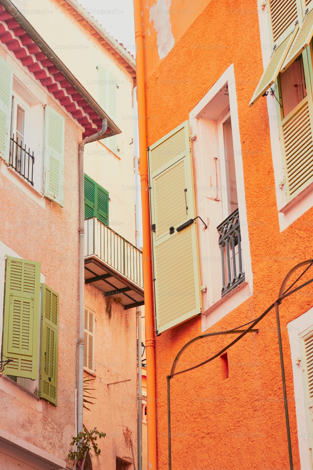 a couple of buildings that have green shutters on them