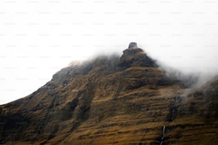 a very tall mountain covered in fog and clouds