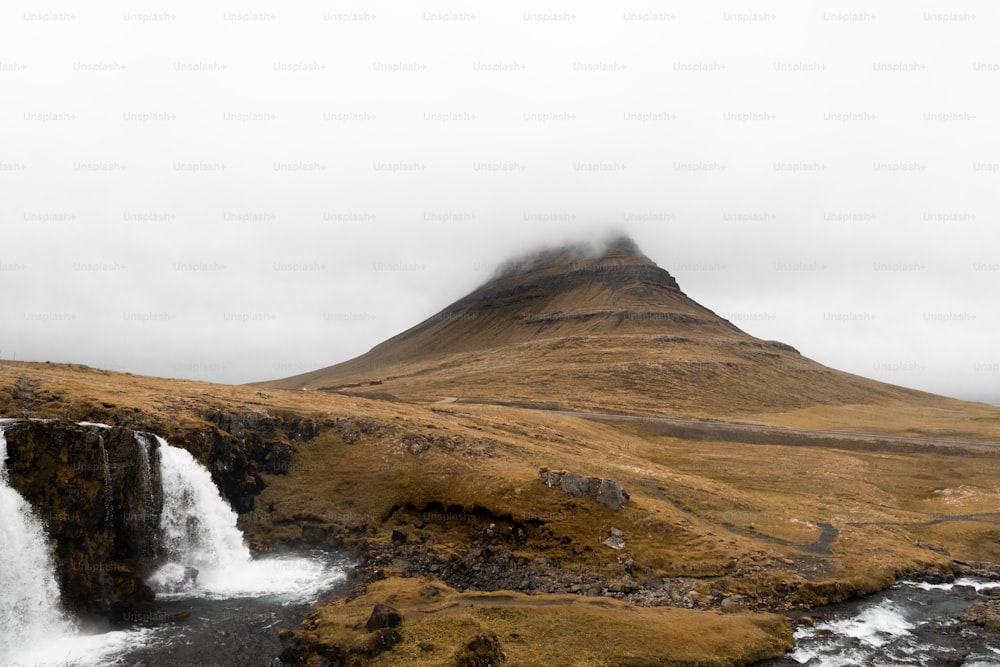 a waterfall with a mountain in the background