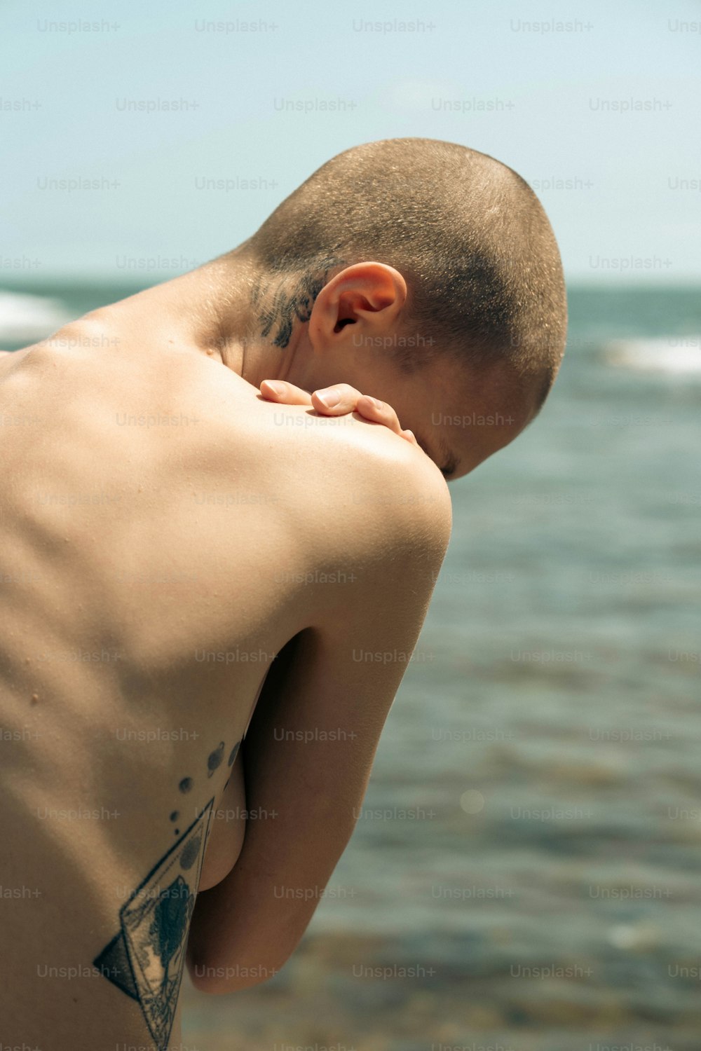 Un uomo con un tatuaggio triangolare sulla schiena