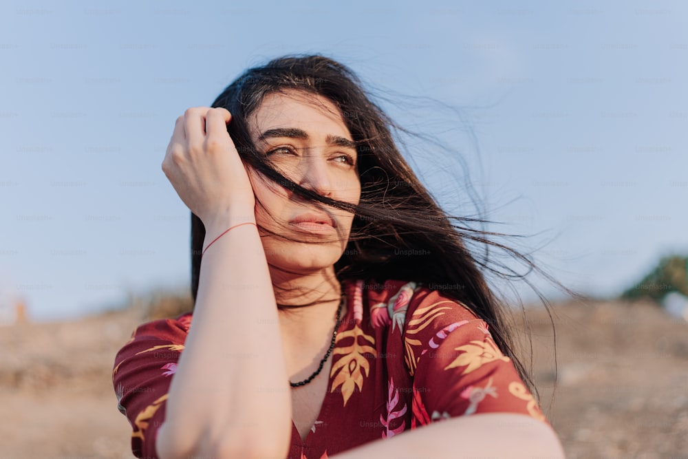 a woman with her hair blowing in the wind