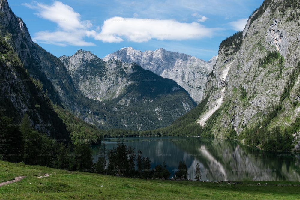 a mountain range with a lake in the foreground