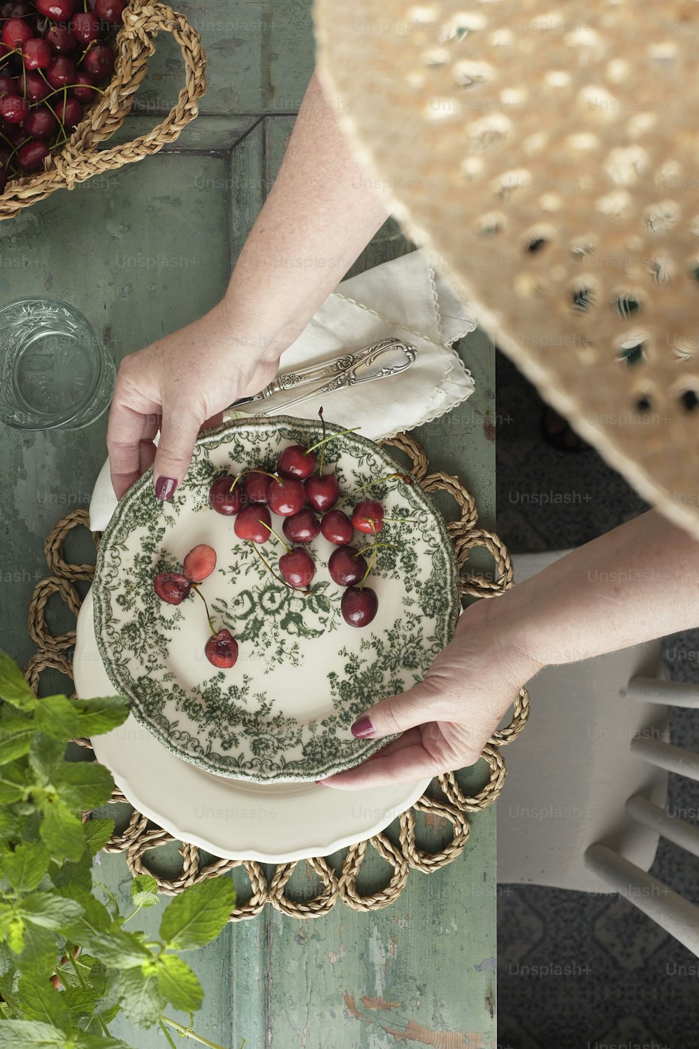 a woman holding a plate with cherries on it