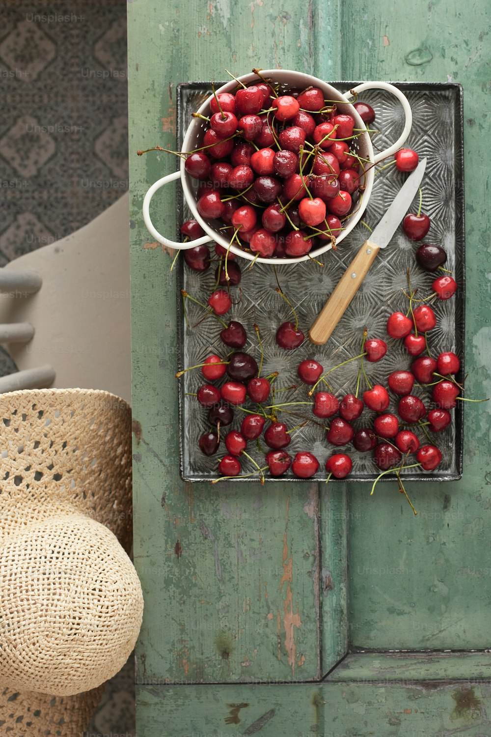 a bowl of cherries on a metal tray