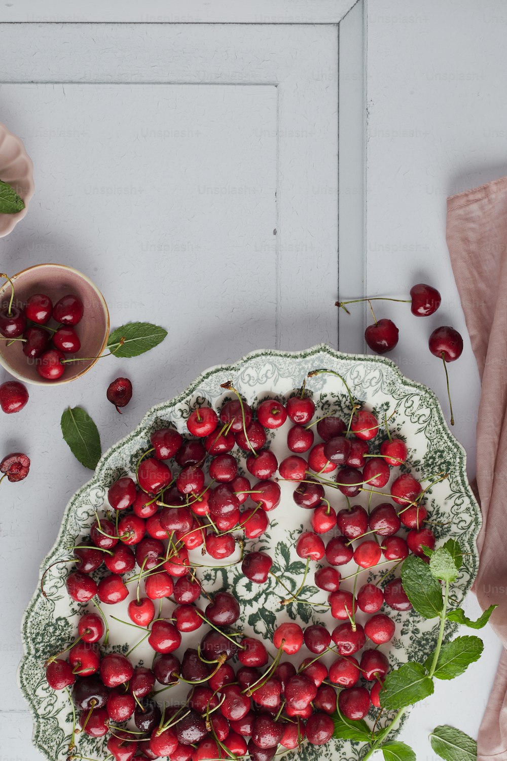 a plate of cherries on a table