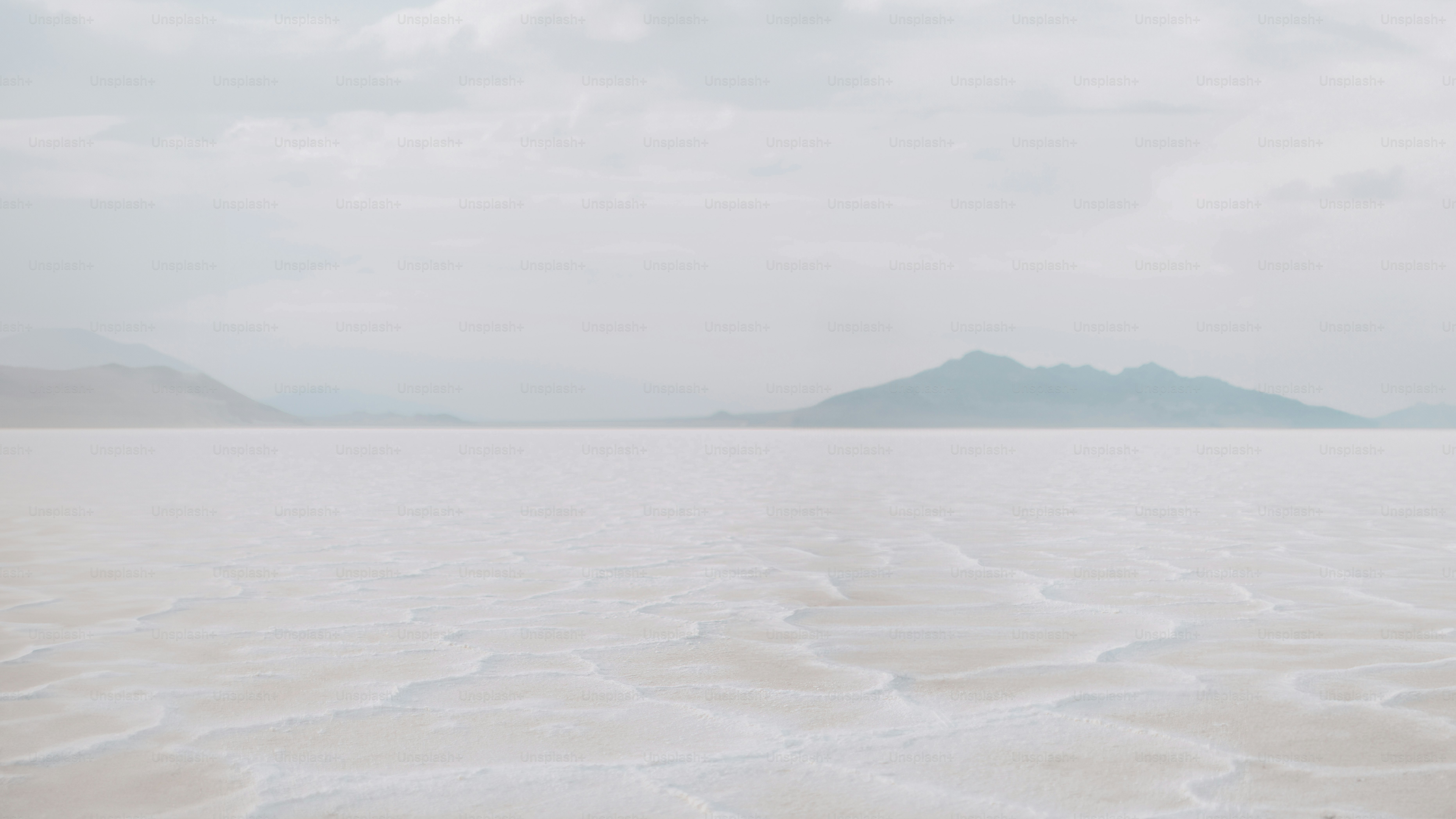 a large body of water with mountains in the background