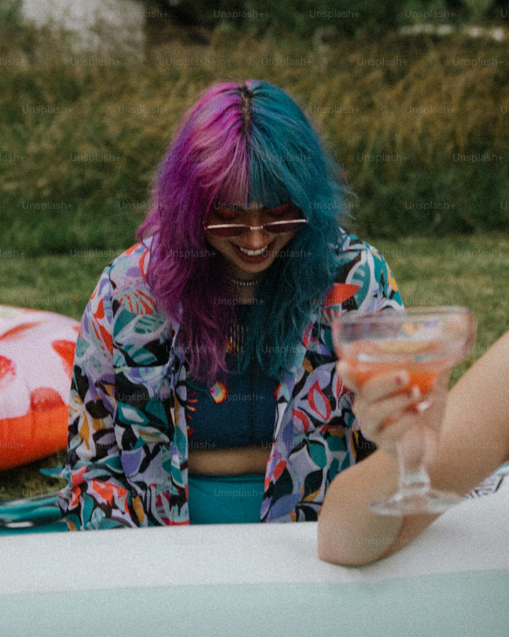 una donna seduta a un tavolo con un bicchiere di vino