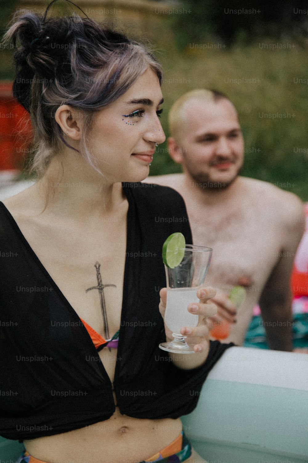 a woman in a bikini holding a drink