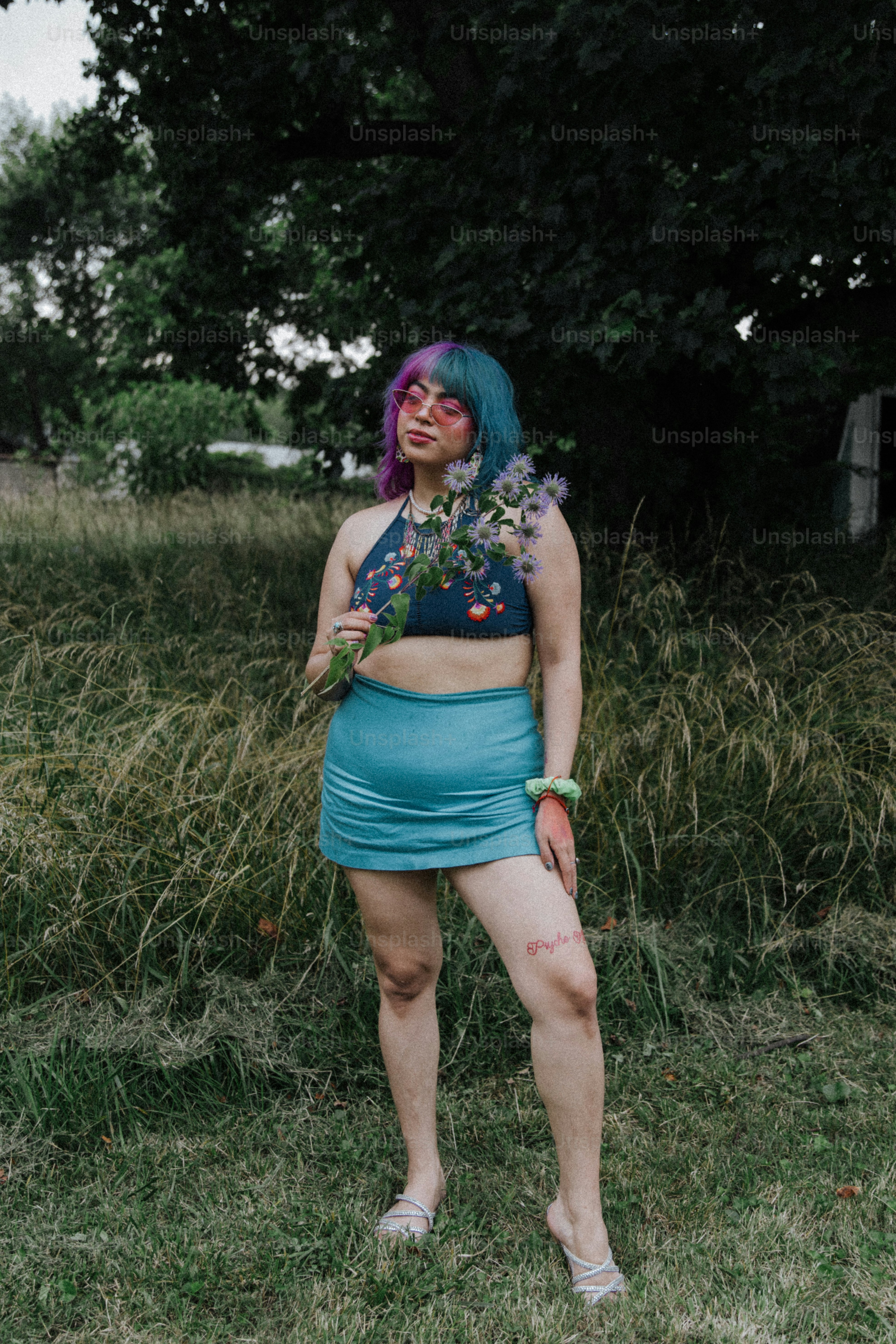 a woman with blue hair wearing a blue skirt