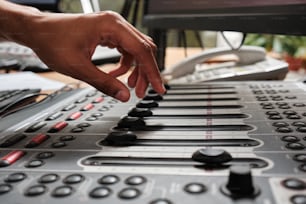 a person is pressing buttons on a sound board