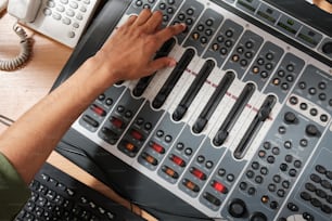 a person pressing buttons on a sound board