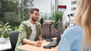 a man sitting at a desk in front of a computer