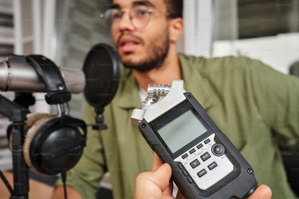 a man in a green shirt is holding a radio