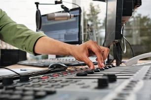 a man is working on a sound mixing console