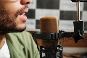 a close up of a person singing into a microphone