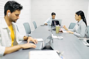 a group of people sitting around a conference table