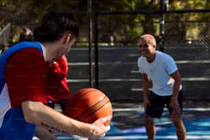 a man holding a basketball on a court