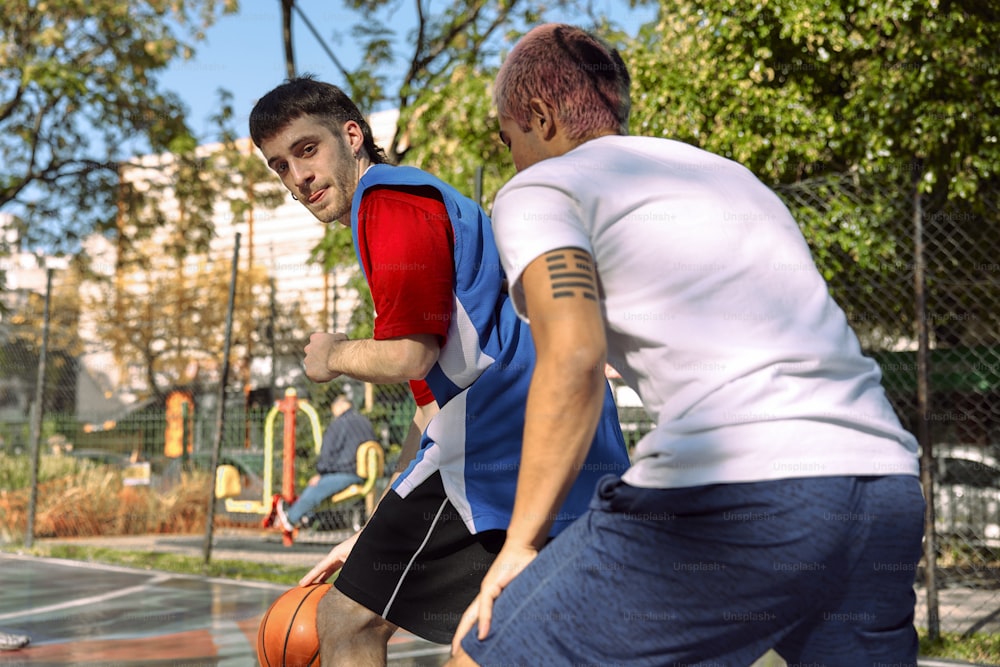 a couple of men playing a game of basketball