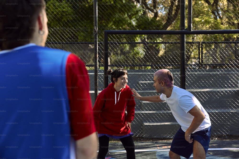 a group of people playing a game of tennis