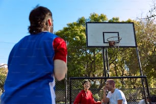 a man standing next to a woman on a basketball court