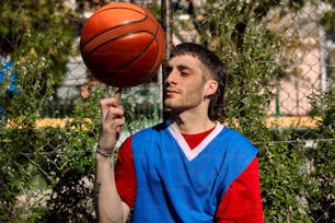 a man holding a basketball up to his face