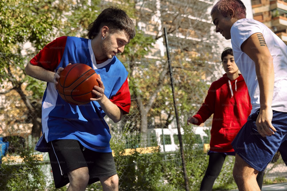 a group of young men playing a game of basketball