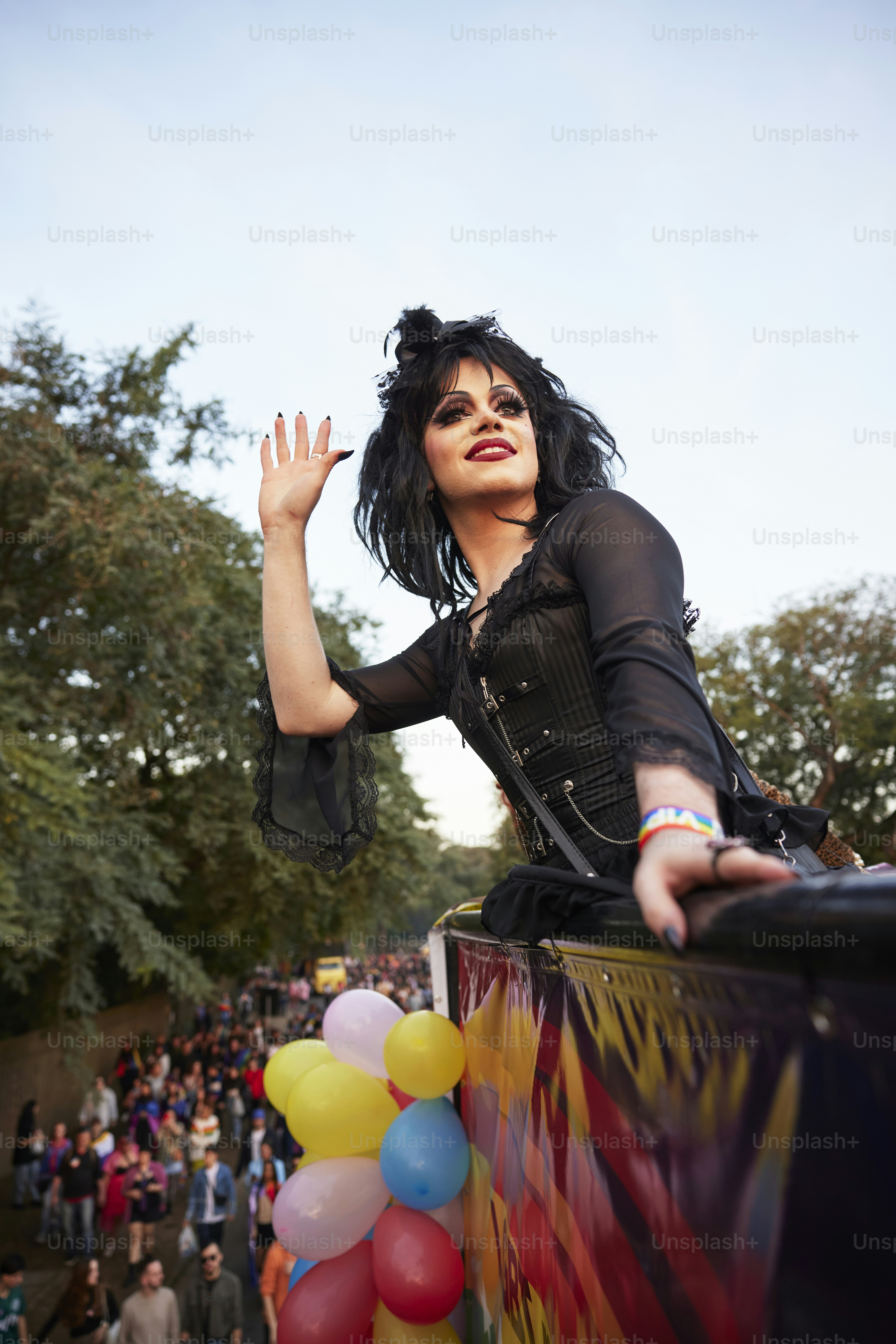 a woman in a costume waving at a crowd